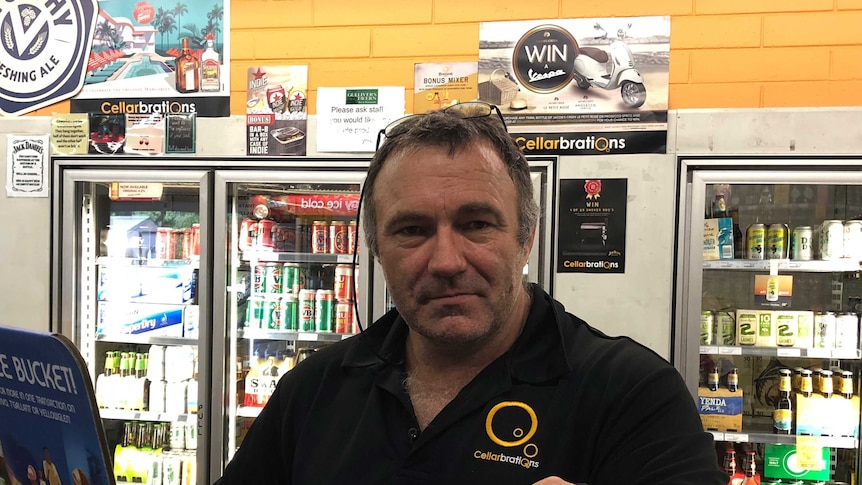 Bottleshop manager Darren Spackman stands beside packaged alcohol in his Kununurra store