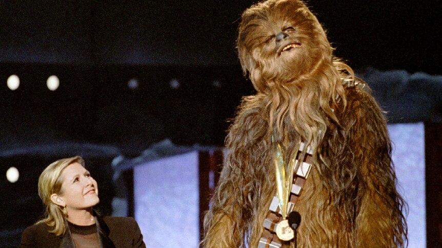 Carrie Fisher presents an award to Chewbacca