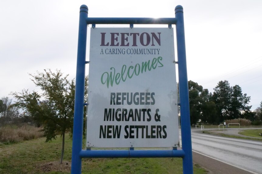 A sign that reads 'Leeton a caring community. Welcomes refugees, migrants and new settlers'.