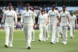 The England men's cricket Test team walk off the field at the Gabba.
