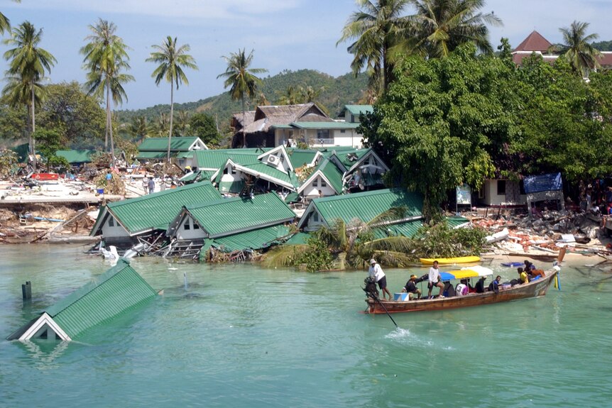 A wide view of a beachside hotel that was destroyed by the tsunami wave and has been flooded