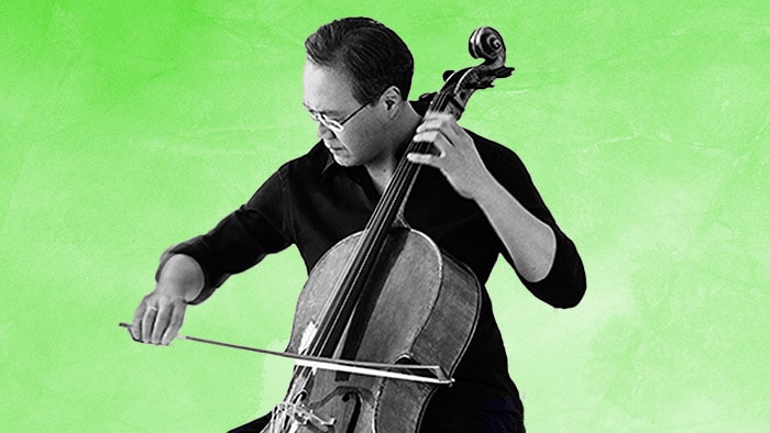 A black-and-white photograph of Yo-Yo Ma playing the cello on a green background.