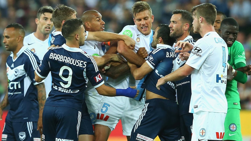 Players push and shove during the Melbourne City - Melbourne Victory match at AAMI Park.