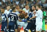 Players push and shove during the Melbourne City - Melbourne Victory match at AAMI Park.