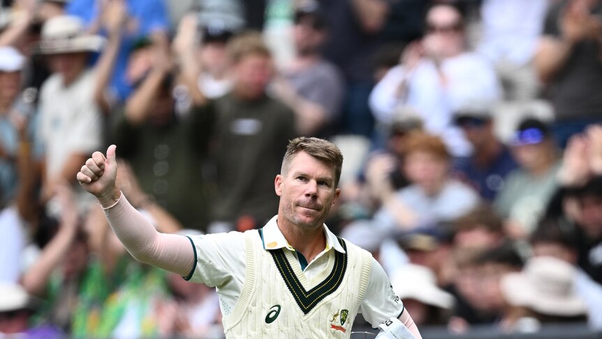 Australia batter David Warner gives the MCG crowd the thumbs-up as he walks off after being dismissed in a Test match.