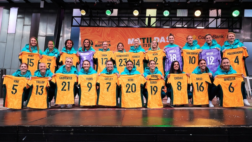 The players on the Matildas FIFA Women's World Cup squad hold up their jerseys