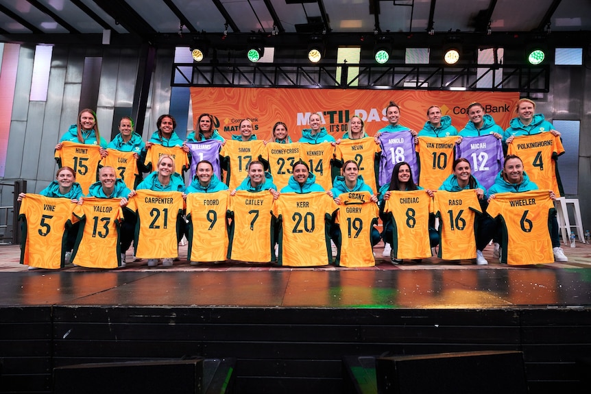 The players on the Matildas FIFA Women's World Cup squad hold up their jerseys