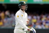 A batsman grimaces as he walks off after being dismissed in a Test match.