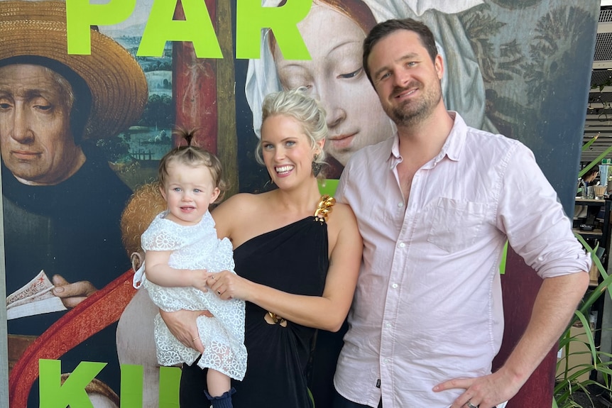 Maggie Kelly s holding her daughter and standing next to her partner