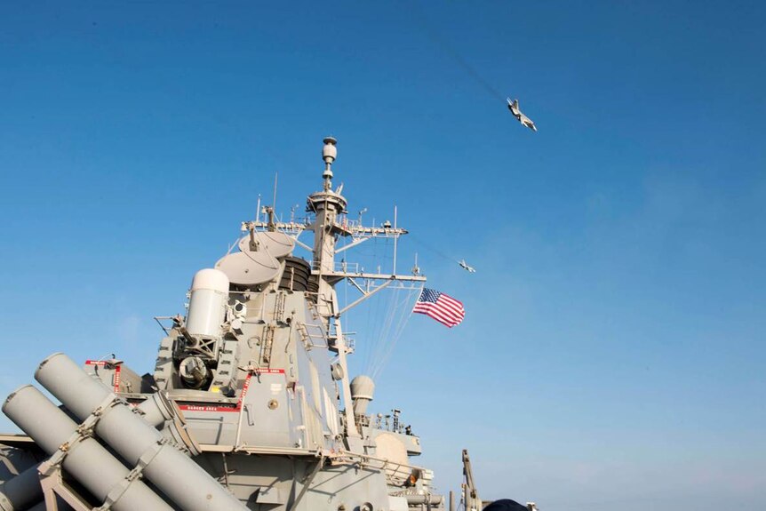 Two Russian aircraft fly over a US destroyer