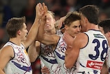 Dockers players get around Jeremy Sharp in celebration of a goal
