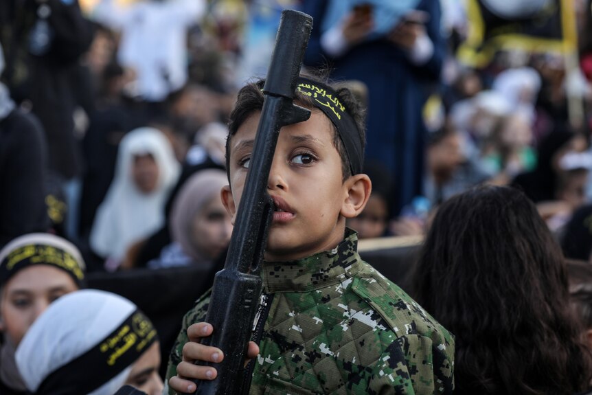 A child holding a gun.