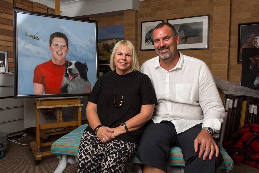 Geoff and Jill Lodge sit next to a portrait of their son.