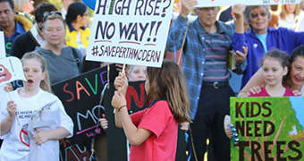 Students and parents holding placards protest against plans to overhaul Perth Modern School