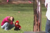 Blurred image of woman and child in a park.