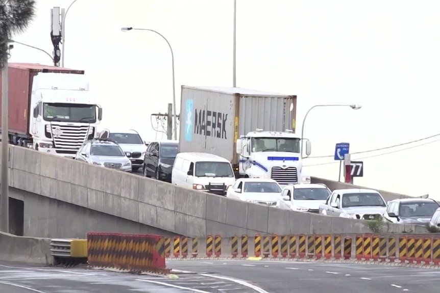 traffic on one side of the road leading down a slope