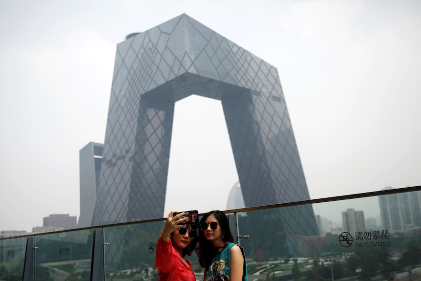 Young people pose for a selfie in Beijing.