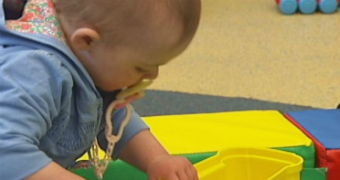 Baby with dummy at child care