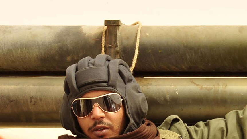 Bombarded: a rebel fighter sits in a vehicle in Ajdabiya.