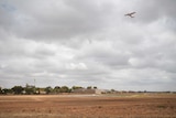 A plane belonging to the International Aviation Alliance flys above the Mildura Airport