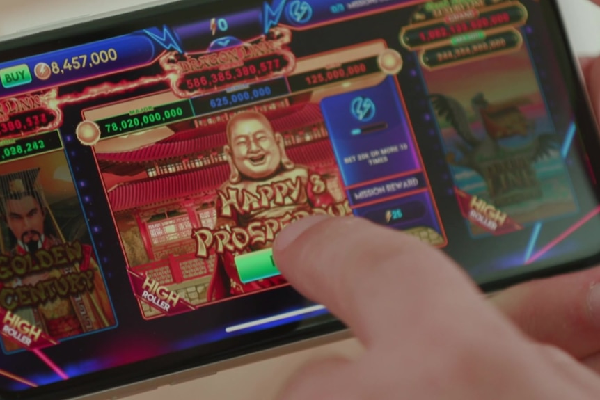 A person points at a mobile phone screen featuring a social casino game in play