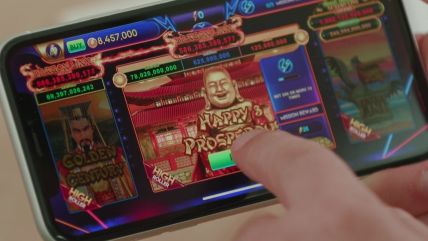 A person points at a mobile phone screen featuring a social casino game in play