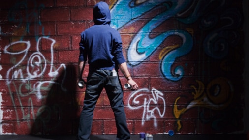 Teenager with cans of spray paint