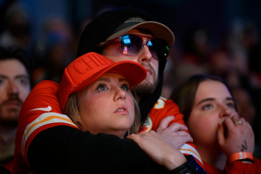 Kansas City Chiefs fans embrace as they watch the team play San Francisco 49ers in Super Bowl LVIII.