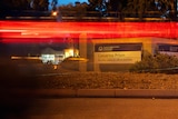 An artsy night picture of the sign at Casuarina Prison