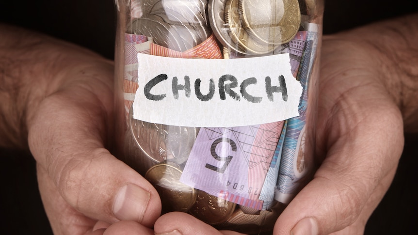 A jar with Church written on it full of money.