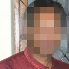 A headshot of a man with his face pixelated to hide his identity.