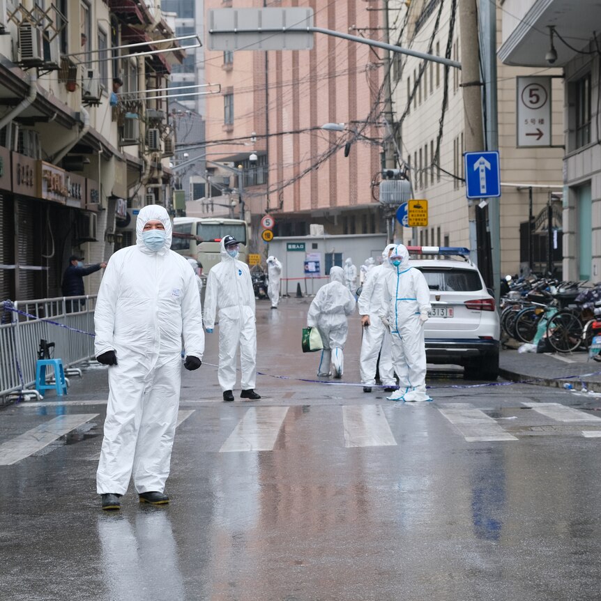 Medical staff in white hazmat suit on Shanghai street China