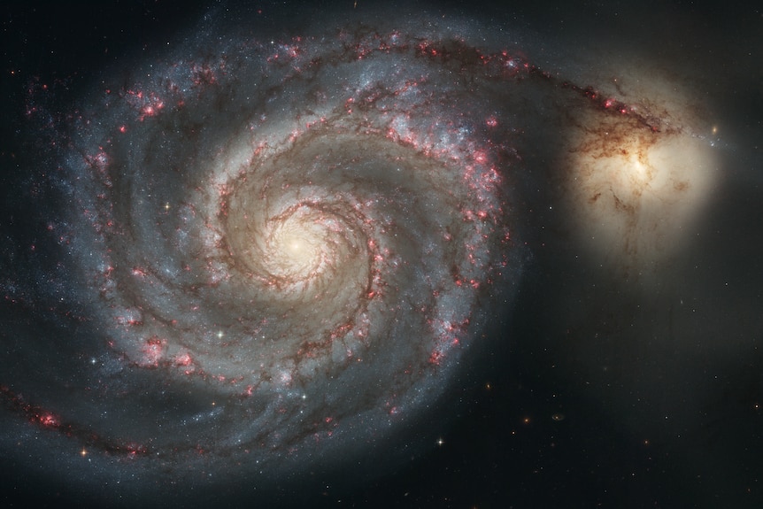 The Hubble image of M51 shows that NGC 5195 is passing behind the Whirlpool.