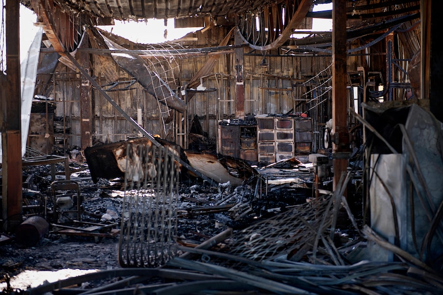 Charred remains of Kerry Kyriacou's joinery business after a fire gutted the building in the industrial area of Woolner