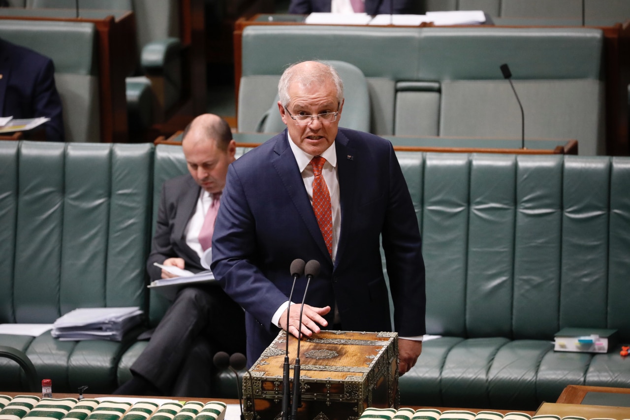 PM Scott Morrison standing at the lectern in Question Time.