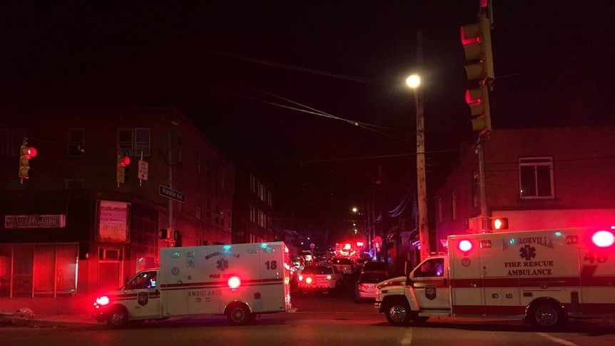 Ambulances gather at scene of shooting at a house in the US.
