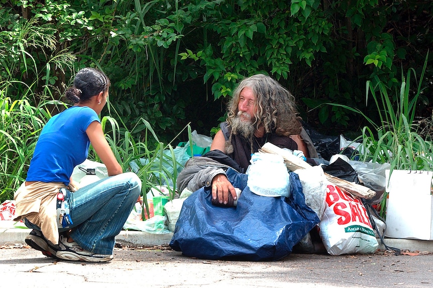 A social worker speaks to Ziggy, a homeless man who lives in Toowong