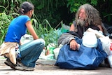 A  social worker speaks to Ziggy, a homeless man who lives in Toowong