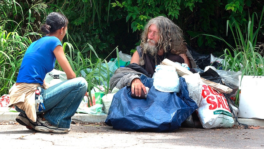A social worker speaks to Ziggy, a homeless man who lives in Toowong
