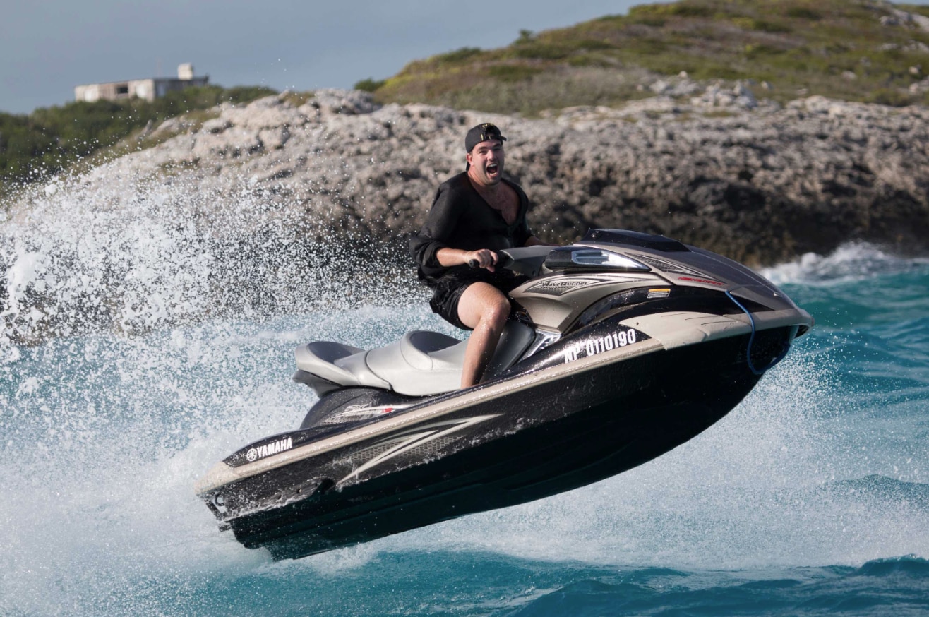 Billy McFarland rides a jetski in the Bahamas in the lead-up to Fyre Festival.