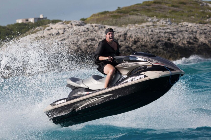 Billy McFarland rides a jetski in the Bahamas in the lead-up to Fyre Festival.