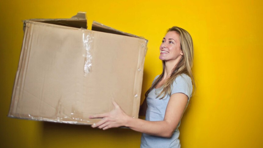 Woman carrying a cardboard box