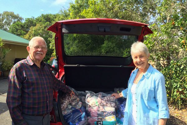 Coral Hallinan (right) and one of the volunteers help pack the handmade teddy bears.