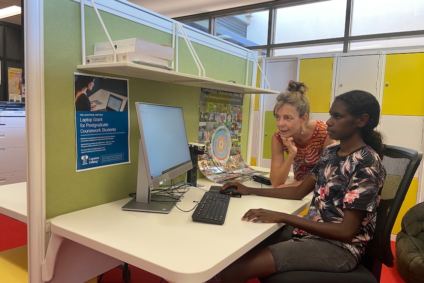 a young Aboriginal woman working at a computer