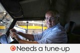 ScoMo behind the wheel of a large automibile.