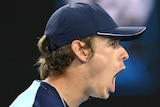 An Australian male tennis player screams out after winning a point at the Australian Open.
