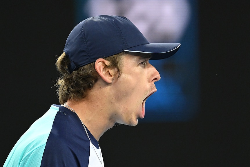 An Australian male tennis player screams out after winning a point at the Australian Open.