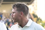 Australia's David Warner (R) raises his bat at stumps versus New Zealand in Perth in November 2015.