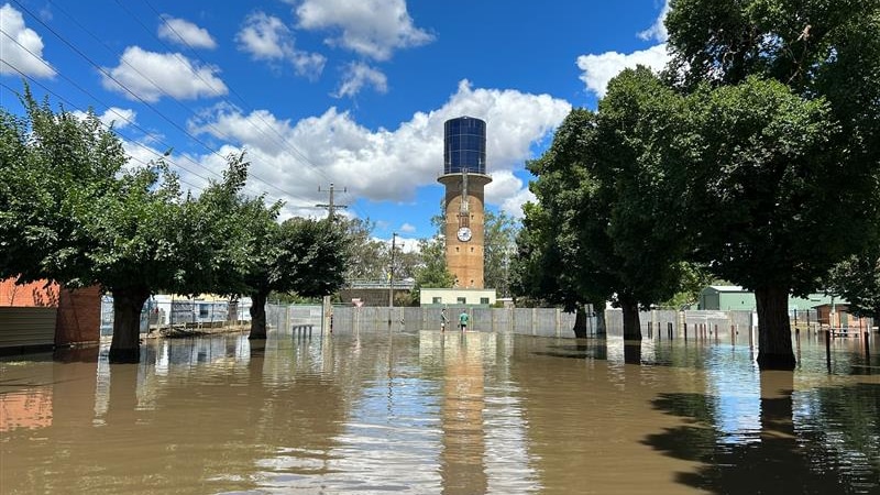 Water laps around a tower with a large clock in Giles St, Rochester.