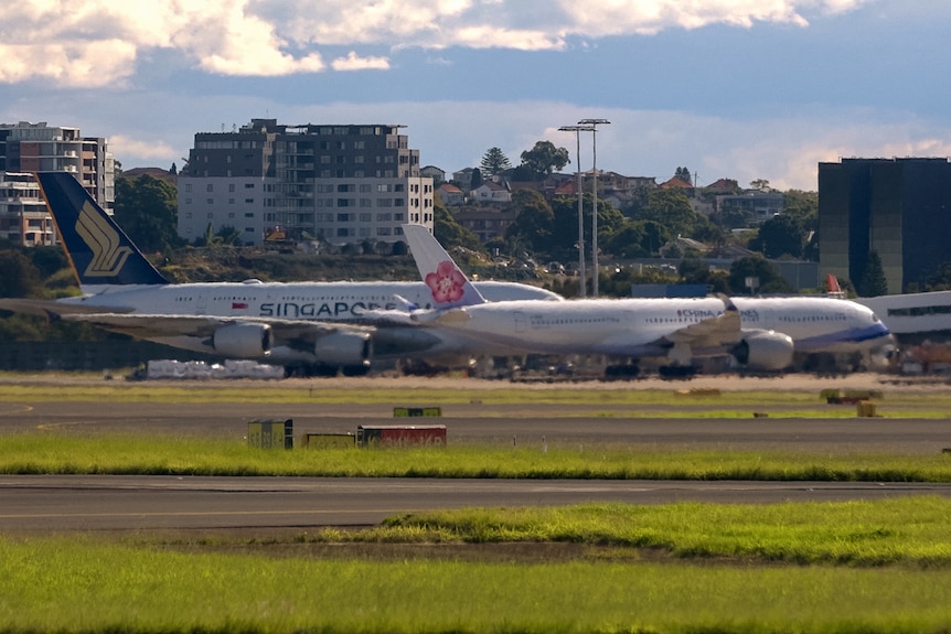 Planes at Sydney Airport, photographed from across the runway.